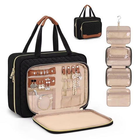 Professional black quilted hanging travel makeup bag open showing jewelry organizer with earring slots ring rolls and necklace hooks plus built-in mirror with hanging hook view on white background